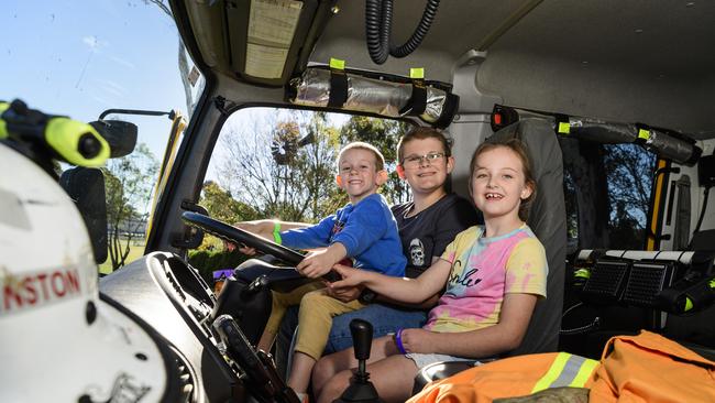 Checking out the Cambooya Rural Fire Brigade truck are (from left) Corbin James, William Bennett and Bonnie Thompson at Sadie's Day Out. The event, a special celebration of the life of five-year-old crash victim Sadie, was held at Cambooya State School, Saturday, June 7, 2025. Picture: Kevin Farmer