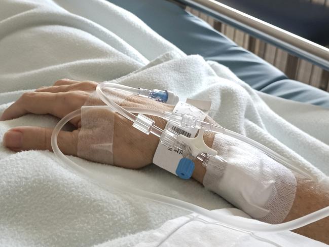 Patient in hospital bed with intravenous route