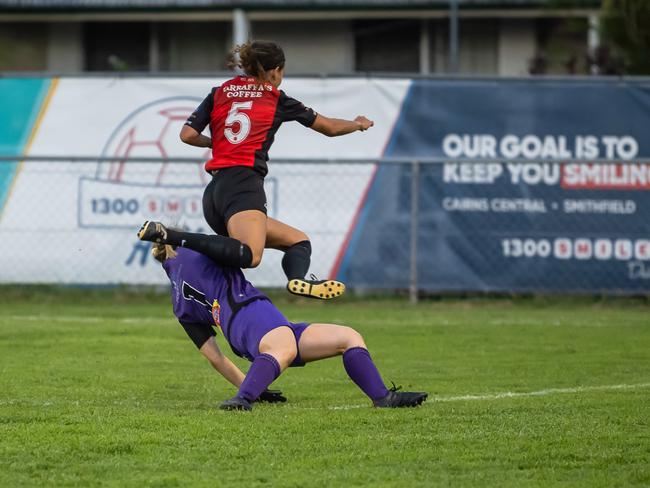 Leichhardt's Daphne Boyd-Tibbotts connects with Edge Hill United goalkeeper Ann Barker in the FNQ Premier League Grand final between Edge Hill United and Leichhardt at Endeavour Park. Picture: Emily Barker