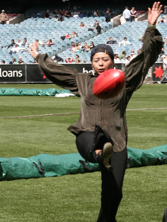 Obligatory singer kicks football AFL photo