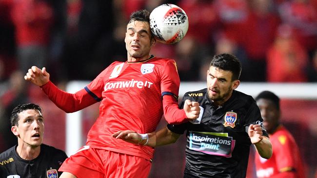 United’s Nikola Mileusnic wins the header against Steven Ugarkovic. Picture: AAP