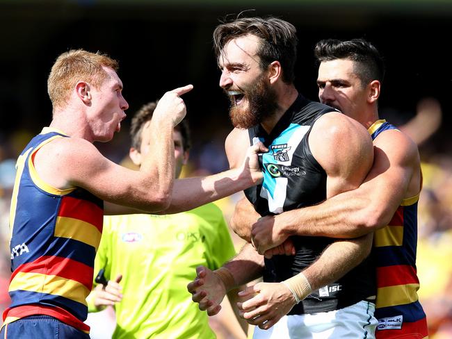 Taylor Walker holds back Charlie Dixon after a confrontation with Tom Lynch. Picture: Sarah Reed.