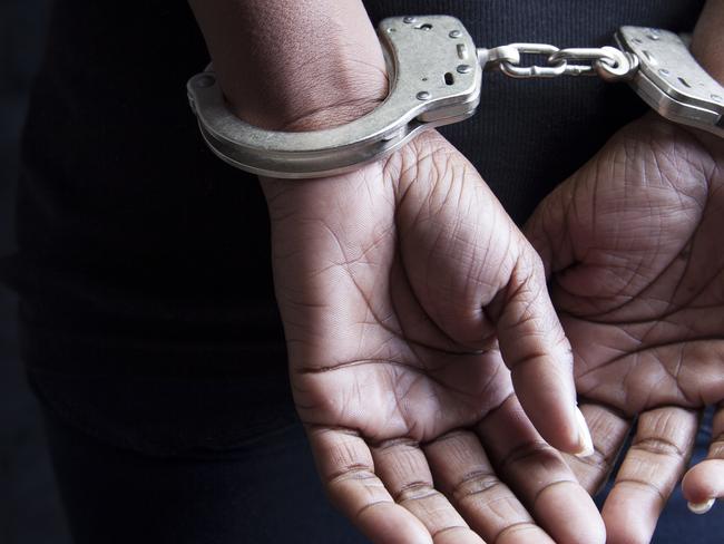 Black woman in handcuffs stock image