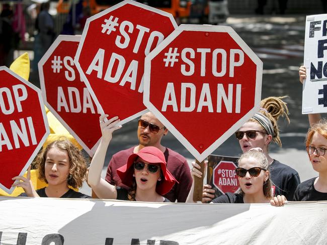 Protestors are seen outside the Queensland Resources Council (QRC) Annual 'State of the Sector' Lunch at the Brisbane Convention and Exhibition Centre in Brisbane, Tuesday, November 21, 2017. (AAP Image/Glenn Hunt) NO ARCHIVING