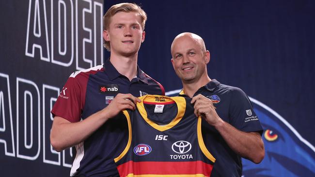 Adelaide Crows number 6 draft pick Fischer McAsey poses with coach Matthew Nicks. Picture: AFL Photos via Getty Images