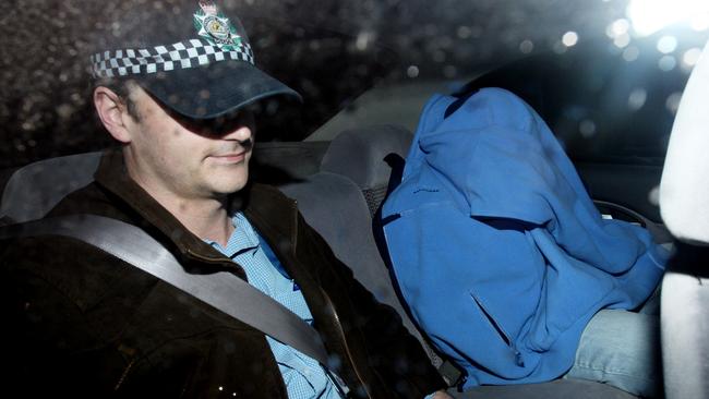 Mark Standen, concealed under a blue blanket, on the day of his arrest.