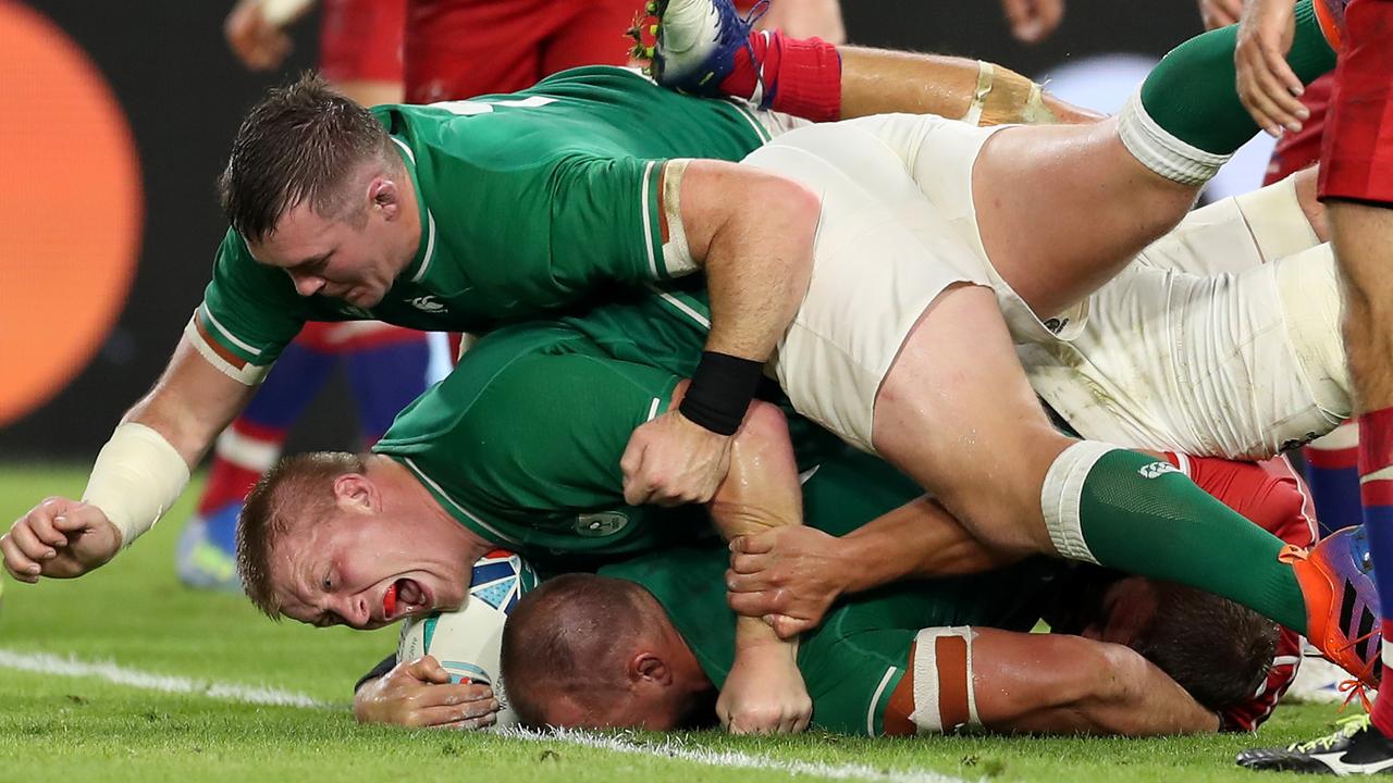 Rhys Ruddock of Ireland scores his team’s third try as John Ryan celebrates.