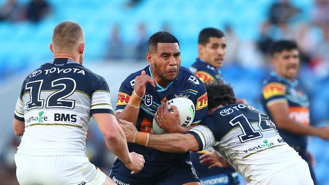 Moeaki Fotuaika of the Titans is challenged during the round 13 NRL match between the Gold Coast Titans and the North Queensland Cowboys at Cbus Super Stadium.