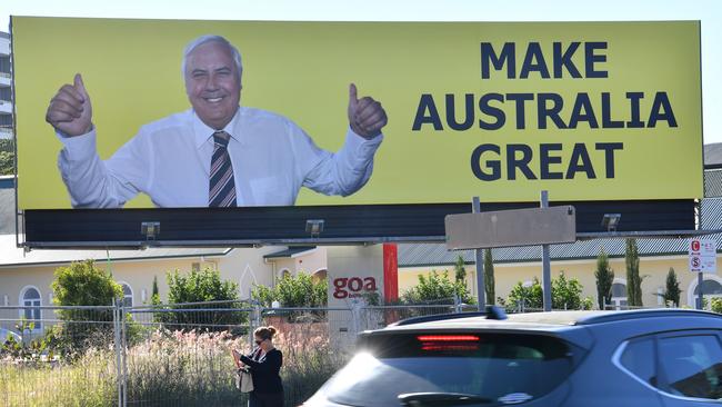 Clive Palmer’s face is beaming from bright yellow billboards in almost every electorate in the country. Picture: AAP