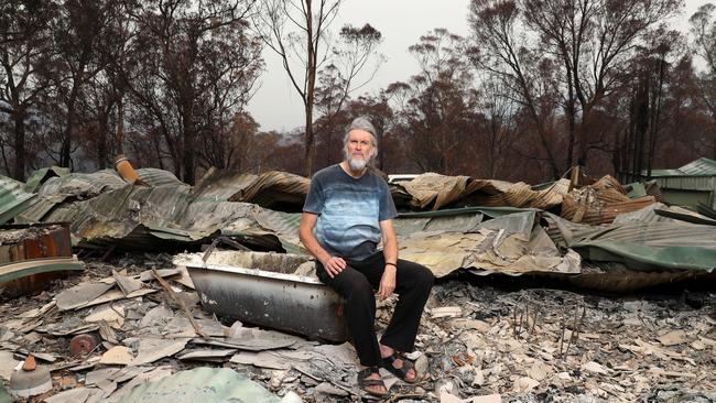 Psychologist Paul Perfrement with what is left of his Yowrie home in the Bega Valley. Picture: Jonathan Ng