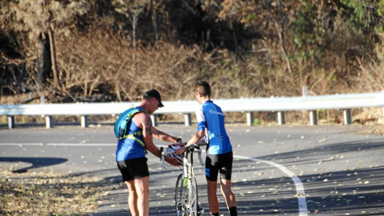 Runner Lee Pratt stops to help a cyclist finish Challenge the Mountain. Picture: Rockhampton Photography Club