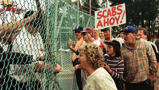 The wife of a sacked dockside worker yells abuse at security guards as unionists attempt to lock a gate at Patricks Stevedore's Port Botany terminal in Sydney.