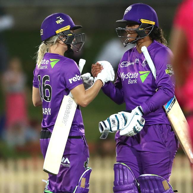 Nicola Carey, left, celebrates a WBBL victory with Hurricanes teammate and import Chloe Tryon last season. Overseas players are not guaranteed to feature this summer. Picture. PHIL HILLYARD