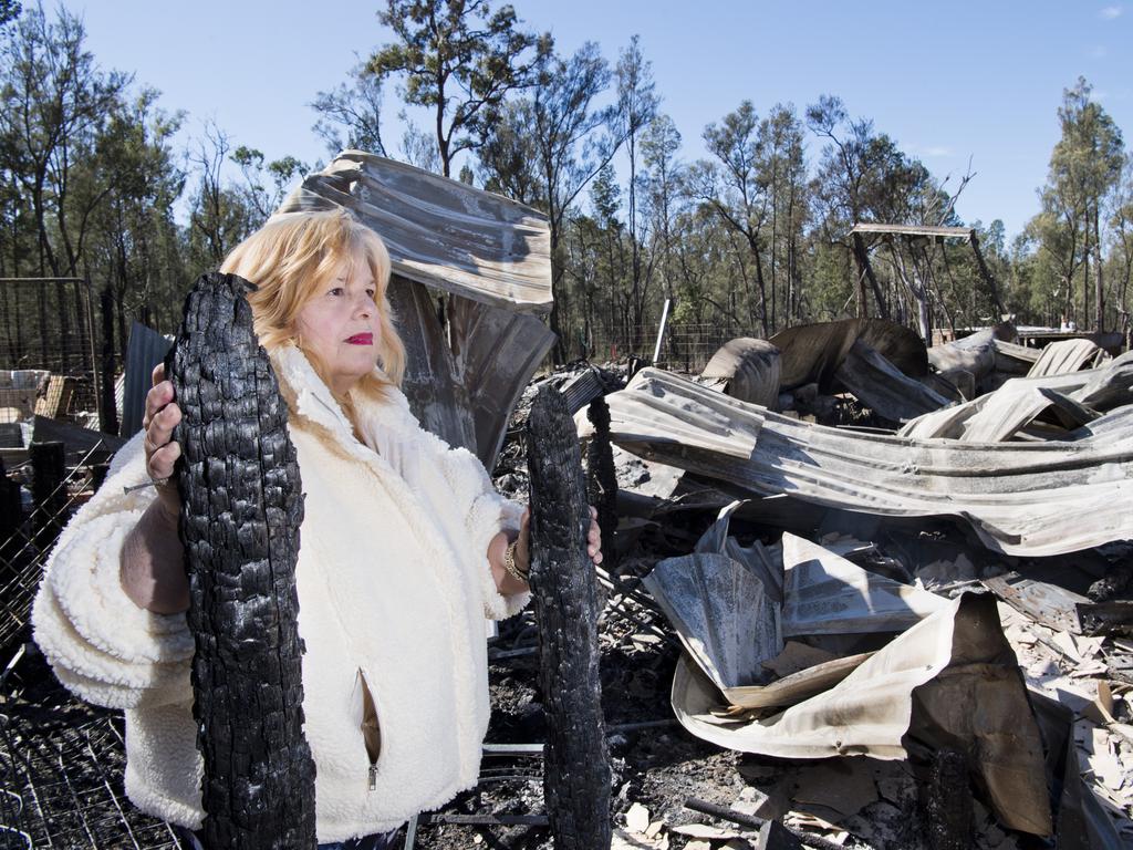 Katherine Greeves looks at her house destroyed by fire in Gardenia Crescent, Millmerran Downs. Wednesday, 15th Jul, 2020.