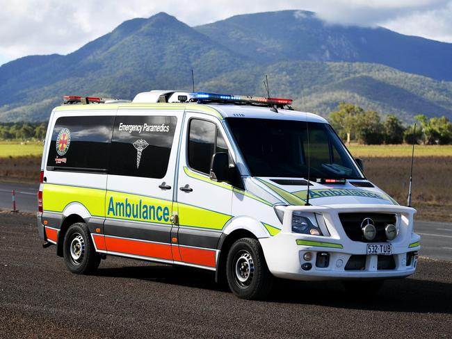 Emergency services attend a fatal car crash on the Bruce Highway, south of Townsville at Mount Surround. Garbage truck driver being looked over by paramedics.  Picture: Alix Sweeney