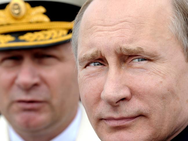 FILE - In this July 26, 2015 file photo, Russian President Vladimir Putin, foreground, reviews a Navy parade in Baltiisk, western Russia. The tide of global rage against the Islamic State group lends greater urgency to ending the jihadis’ ability to operate at will from a base in war-torn Syria. That momentum could also force a reevaluation of what to do about President Bashar Assad’s future and puts a renewed focus on the position of his key patrons, Russia and Iran. (Mikhail Klimentyev/Sputnik, Kremlin Pool Photo via AP, File)