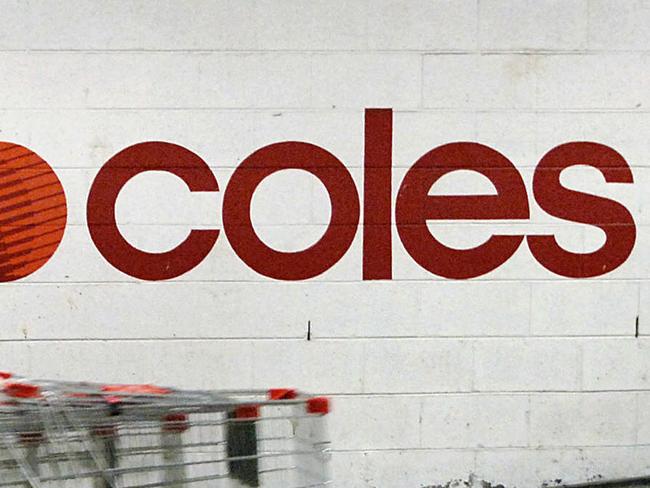 An employee collects shopping trolleys outside a Coles supermarket in Sydney on 13 Apr 2007 : PicJack/Attey /Bloomberg /News - supermarket entrance sign signs logo logos