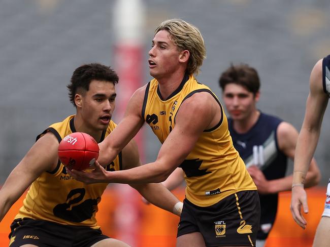 Luke Urquhart fires off a handball on Sunday. Picture: Paul Kane/AFL Photos/via Getty Images.