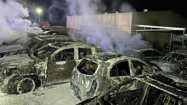 Two men have been charged by destroying property by fire after allegedly torching nine cars in a storage facility.