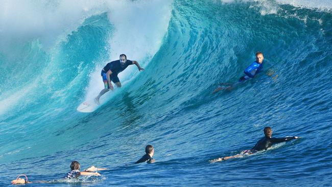 Surfers at Snapper Rocks yesterday where swells are particularly big, whipped up by an ex cyclone. Photo: Scott Powick