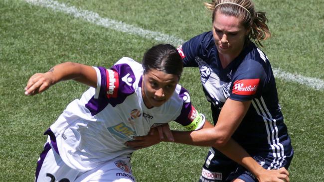 Perth Glory striker Sam Kerr, left, struggles to break free from Melbourne Victory defender Danielle Waetherholt during the W-League semi-final on Sunday. Picture: AAP