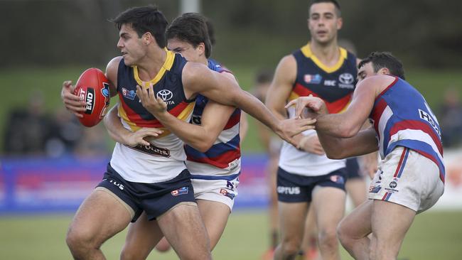 Adelaide’s Darcy Fogarty is tackled by Central District’s Jaxon Neagle during the Crows’ commanding win at Elizabeth Oval. Picture: AAP Image/Dean Martin