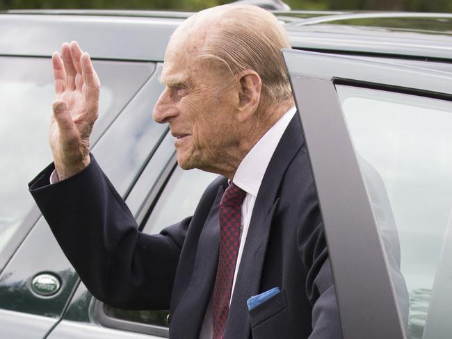 The Duke of Edinburgh Prince Philip waves to well wishers after driving the car to arrive with Britain's Queen Elizabeth II,  for the Bentley Motors Royal Windsor Cup Final at Guards Polo Club, Windsor Great Park, England, Sunday June 25, 2017.  In a fun event England competed against Scotland in the Penny Farthing International Polo match, during the Bentley Motors Royal Windsor Cup Final polo meeting. (Steve Parsons/PA via AP)