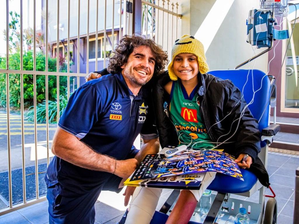 Roman Purcell, 12, with his favourite Cowboys player Jake Granville.