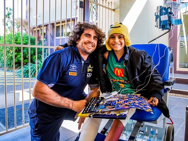 Roman Purcell, 12, with his favourite Cowboys player Jake Granville.