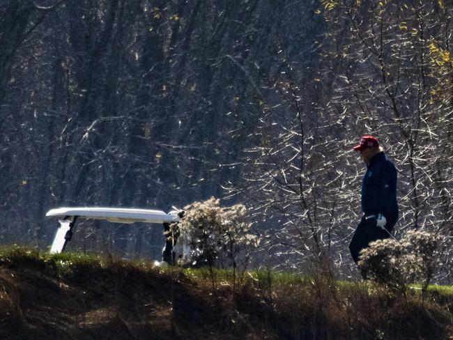 Donald Trump cut a lonely figure on the golf course in Sterling, Virginia, as his supporters marched in Washington. Picture: AFP