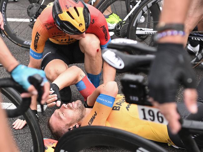 Team Bahrain rider Italy's Sonny Colbrelli lies on the road after falling down during the 1st stage of the 107th edition of the Tour de France cycling race, 156 km between Nice and Nice, on August 29, 2020. (Photo by Anne-Christine POUJOULAT / AFP)