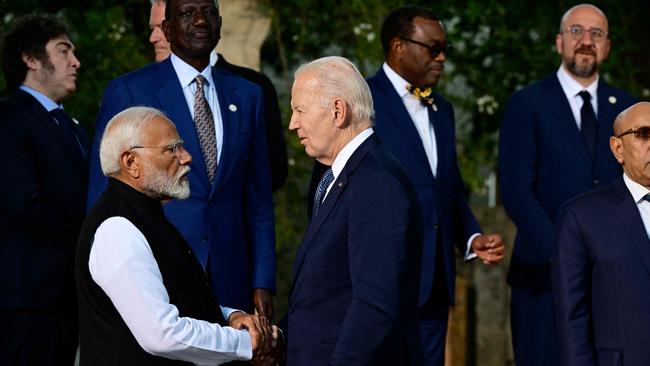Indian Prime Minister Narendra Modi shakes hands with US President Joe Biden (C) before a family photo with G7 heads of States. Picture: Tiziana FABI / AFP.