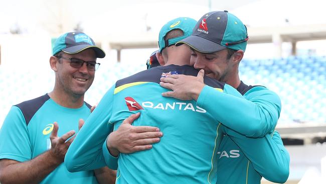 Travis Head receives his baggy green cap from Nathan Lyon.