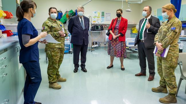 Royal Commissioners' Mr Nick Kaldas (centre right), Dr Peggy Brown (centre) and the Honourable James Douglas, learn about the role of Lavarack Health Centre during their visit to the 3rd Brigade at Lavarack Barracks. Picture: Brodie Cross