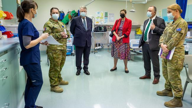 Royal Commissioners' Mr Nick Kaldas (centre right), Dr Peggy Brown (centre) and the Honourable James Douglas, learn about the role of Lavarack Health Centre during their visit to the 3rd Brigade at Lavarack Barracks. Picture: Brodie Cross