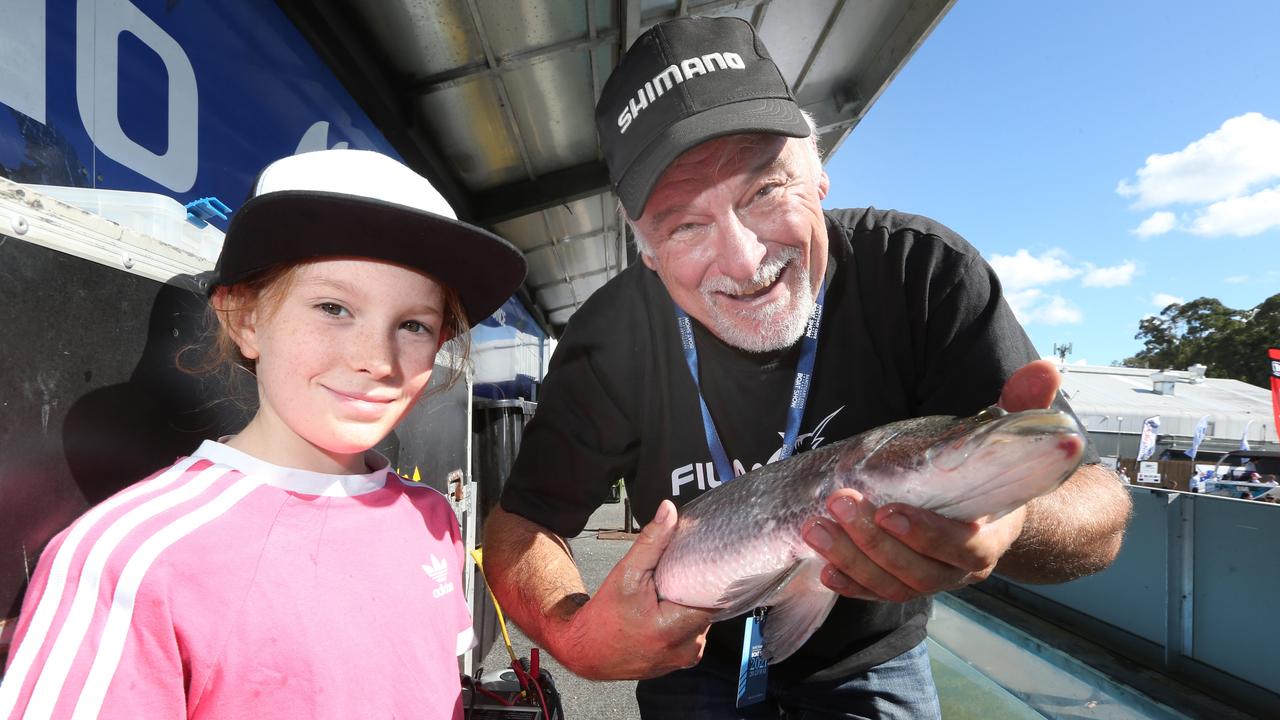 Shimano Fishing Take Show presenter David Moss shows off his catch to 10-year-old Lucy Pogson at the Sanctuary Cove International Boat Show. Picture: Mike Batterham