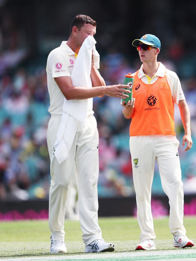 Austin Waugh carries drinks to Josh Hazlewood during Day 1 of 4th Test match between Australia and India at the SCG. Picture. Phil Hillyard