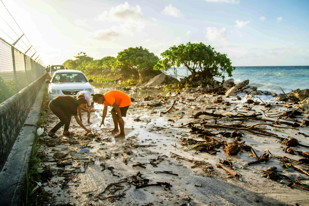 A photo taken on December 6, 2021 shows high-tide flooding and debris covering the road to the airport in the Marshall Islands capital Majuro