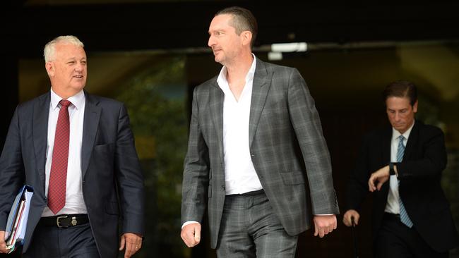 Former CBA executive Jon Waldron, centre, pictured outside court in 2018. Picture: Jeremy Piper