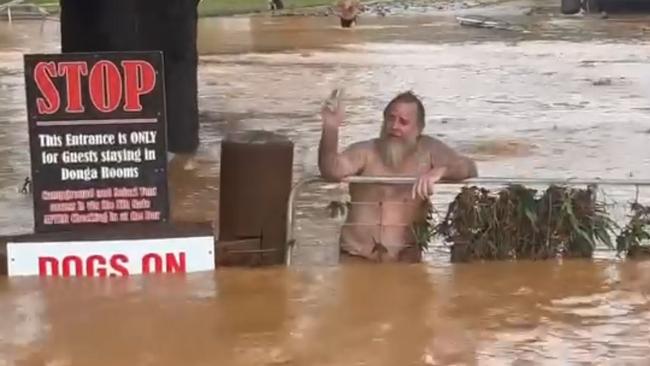 A loveable larrikin, “Jonesy” wades through chest deep flood waters to chat to his mate. Picture: Gavin Dear/ Facebook