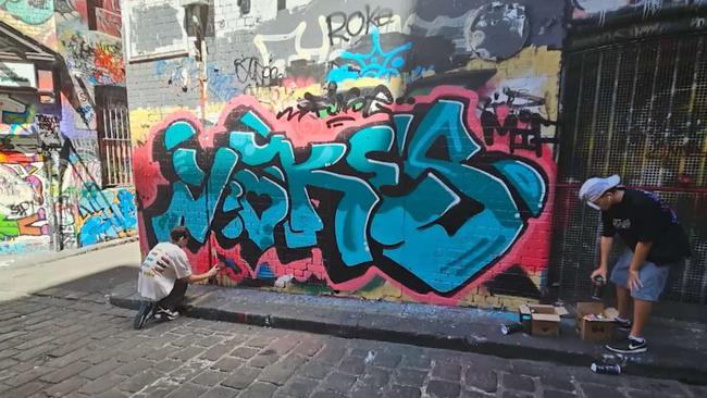 A photo of Beau Liddell tagging a legal wall in Melbourne, shown in a montage at his funeral