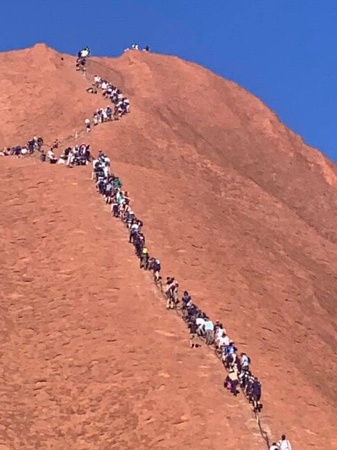 Tourists climb Uluru this week. Picture: Glenn Minett