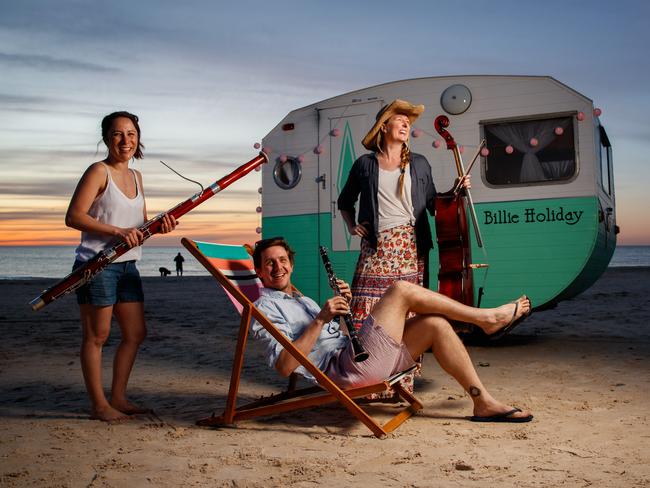 ASO musicians Gemma Phillips (Cello), Dean Newcomb (Clarinet) and Jackie Newcomb (Contrabassoon) with Billie Holiday caravan on September 28, 2020 at Seacliff. Picture Matt Turner.