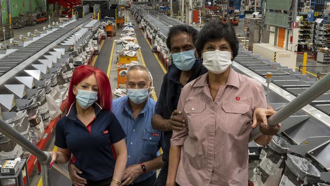 Couples Niki and Francois LeClair and Bernadette and Tilak Gunasekera say they love working together at Australia Post. Picture: Supplied