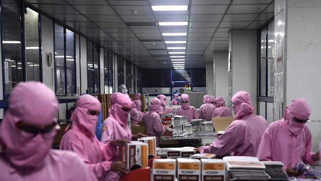 Workers at the Hindustan Syringes factory. Picture: AFP