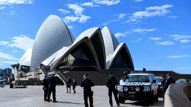 NSW Police officers patrol the Sydney Opera House forecourt, as part of a major police operation to crack down on a planned anti-lockdown protest. Picture: NCA NewsWire/Bianca De Marchi