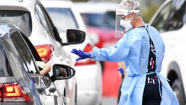 A health worker processes members of the public at a drive through Covid-19 testing clinic at Murarrie in Brisbane. Picture: NCA NewsWire / Dan Peled