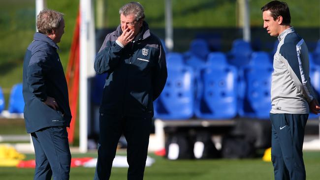 Roy Hodgson the manager of England talks with his assistants Ray Lewington and Gary Neville.