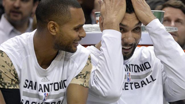 San Antonio Spurs forward Tim Duncan, right, laughs with guard Patty Mills.