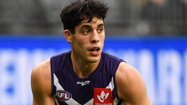 PERTH, AUSTRALIA - AUGUST 08: Adam Cerra of the Dockers looks at his options during the 2021 AFL Round 21 match between the Fremantle Dockers and the Brisbane Lions at Optus Stadium on August 8, 2021 in Perth, Australia. (Photo by Daniel Carson/AFL Photos via Getty Images)